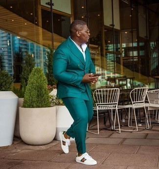 Teal Suit Outfits: A teal suit looks especially elegant when teamed with a white short sleeve shirt in a modern man's ensemble. Add white print leather low top sneakers to the mix to bring a sense of stylish nonchalance to your look.