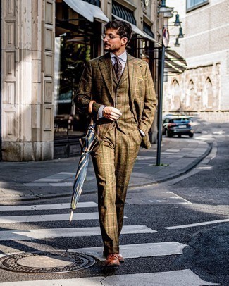 Dark Green Suit Outfits: Consider pairing a dark green suit with a white dress shirt if you're aiming for a proper, dapper ensemble. Does this ensemble feel all-too-polished? Enter a pair of tobacco leather brogues to shake things up.