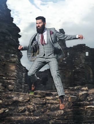 Marrying a grey plaid three piece suit and a white and blue vertical striped dress shirt will create a classic, rugged silhouette. When in doubt about the footwear, introduce a pair of tan leather brogues to the equation.