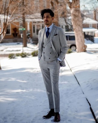 Grey Three Piece Suit Outfits: Swing into something refined and timeless in a grey three piece suit and a light blue dress shirt. Add dark brown leather brogues to this outfit to loosen things up.