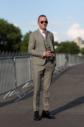 Grey Plaid Three Piece Suit Outfits: Marrying a grey plaid three piece suit with a white dress shirt is an on-point idea for a dapper and refined getup. For an on-trend on and off-duty mix, finish off with black leather casual boots.