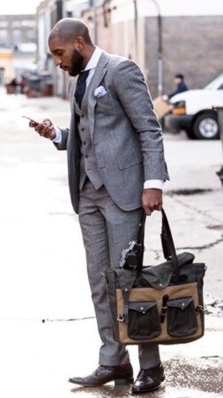 Grey Three Piece Suit Outfits: Make a grey three piece suit and a white dress shirt your outfit choice for a seriously smart look. For times when this getup looks too perfect, tone it down with a pair of dark brown leather derby shoes.