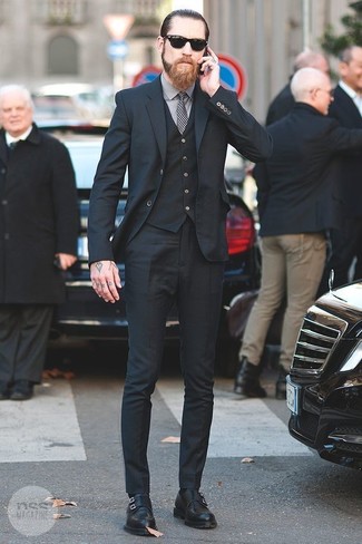 Solid proof that a black three piece suit and a grey dress shirt are awesome when teamed together in a polished ensemble for a modern dandy. Finish off with black leather double monks to punch up this outfit.