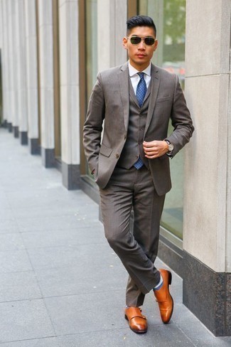 Grey Three Piece Suit Outfits: This combo of a grey three piece suit and a white dress shirt is a foolproof option when you need to look truly dapper. A pair of tobacco leather double monks immediately ups the cool of this look.