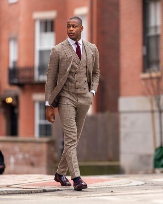 Tan Three Piece Suit Outfits: You're looking at the indisputable proof that a tan three piece suit and a white dress shirt look amazing when paired together in an elegant ensemble for today's man. A pair of burgundy leather loafers easily bumps up the wow factor of your outfit.