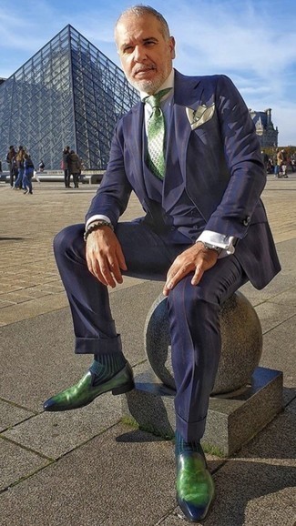 Navy Vertical Striped Three Piece Suit Outfits: Solid proof that a navy vertical striped three piece suit and a light blue dress shirt look amazing when worn together in a sophisticated getup for today's guy. Give an easy-going touch to this outfit by finishing with a pair of green leather loafers.