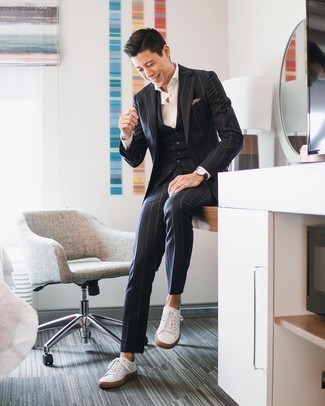 Black and White Vertical Striped Suit Outfits: Swing into something elegant yet on-trend in a black and white vertical striped suit and a white dress shirt. Get a bit experimental in the footwear department and dial down this outfit by finishing off with white canvas low top sneakers.