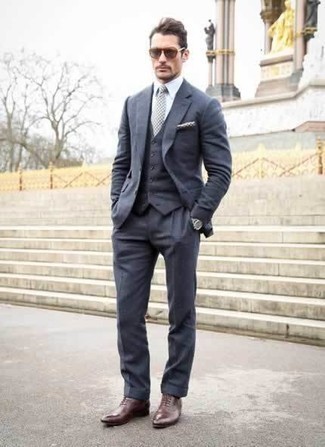 Grey Check Tie Outfits For Men: For masculine sophistication with a contemporary spin, you can rock a navy three piece suit and a grey check tie. Burgundy leather oxford shoes are guaranteed to add an air of stylish casualness to this ensemble.