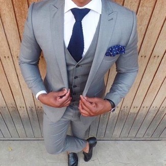 Navy and White Knit Tie Outfits For Men: A grey three piece suit and a navy and white knit tie are absolute essentials if you're piecing together a refined closet that matches up to the highest sartorial standards. Play down the dressiness of this look by rounding off with black leather tassel loafers.