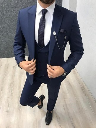 Navy Three Piece Suit Outfits: Channel your inner Kingsman agent and go for a navy three piece suit and a white dress shirt. Show off your laid-back side by finishing with a pair of black leather tassel loafers.