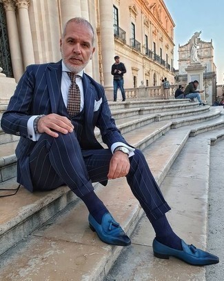 Grey Beaded Bracelet Outfits For Men: If it's ease and practicality that you're seeking in menswear, rock a navy vertical striped three piece suit with a grey beaded bracelet. Take a classier route when it comes to shoes by sporting blue leather tassel loafers.