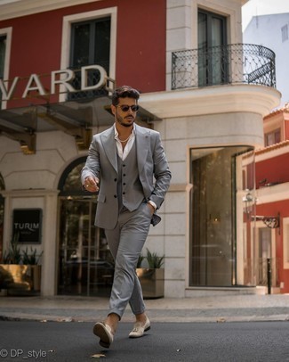 Grey Three Piece Suit Outfits: Channel your inner British gentleman and make a grey three piece suit and a white dress shirt your outfit choice. A pair of beige suede tassel loafers will add a more dressed-down aesthetic to the ensemble.