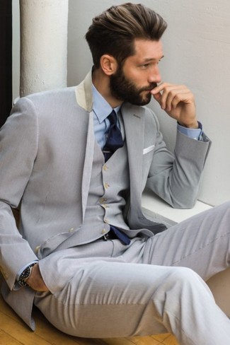 Black Watch Outfits For Men: A grey three piece suit and a black watch are great menswear essentials that will integrate wonderfully within your current outfit choices.