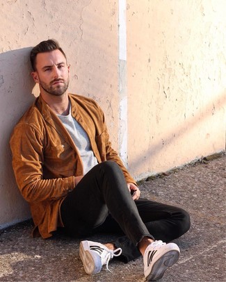 Dark Brown Bomber Jacket Outfits For Men: A dark brown bomber jacket and black skinny jeans are wonderful menswear essentials that will integrate brilliantly within your daily styling routine. White leather low top sneakers are the glue that will pull your outfit together.