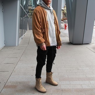Beige Canvas High Top Sneakers Outfits For Men: This pairing of a tobacco suede bomber jacket and black cargo pants is proof that a pared down off-duty outfit doesn't have to be boring. Add a mellow feel to by finishing with a pair of beige canvas high top sneakers.