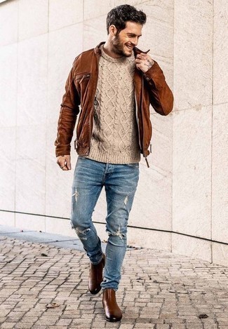 Beige Cable Sweater Outfits For Men: For something more on the cool and casual end, go for a beige cable sweater and blue ripped jeans. If you wish to easily up the style ante of this outfit with one item, why not complete your ensemble with a pair of brown leather chelsea boots?
