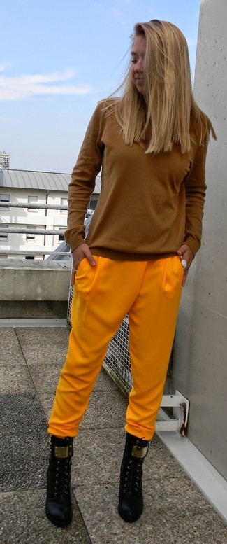 Orange Pajama Pants Outfits For Women: No matter where the day takes you, you'll be stylishly ready in this casual combination of a tobacco long sleeve t-shirt and orange pajama pants. To give this outfit a more polished aesthetic, why not complement your look with black leather ankle boots?