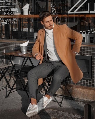 Tobacco Overcoat Outfits: Irrefutable proof that a tobacco overcoat and a charcoal suit are awesome when married together in a sophisticated look for a modern gentleman. Why not go for white athletic shoes for a little edge?