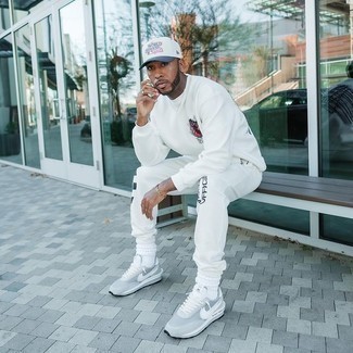 White Track Suit Outfits For Men: Reach for a white track suit to pull together an interesting and casual street style ensemble. In the footwear department, go for something on the dressier end of the spectrum and complement this ensemble with a pair of grey athletic shoes.