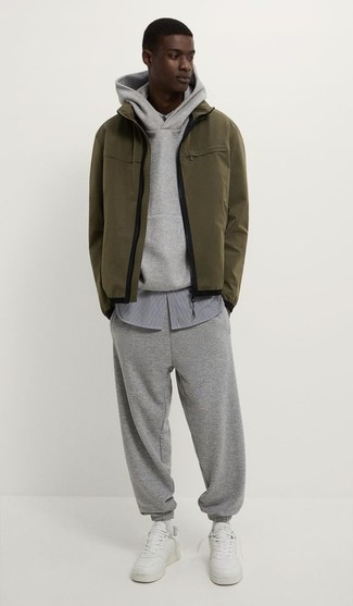 Men's White Leather Low Top Sneakers, Grey Track Suit, Grey Vertical Striped Long Sleeve Shirt, Olive Windbreaker