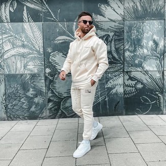 White Leather Low Top Sneakers Summer Outfits For Men: Wear a beige track suit to pull together an edgy and absolutely dapper ensemble. Ramp up this whole outfit by finishing with a pair of white leather low top sneakers. If you're in search of a summer-appropriate look, here is a great one.