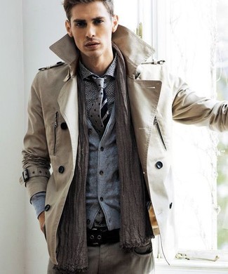 Go for a straightforward but dapper option by teaming a tan trenchcoat and grey jeans.