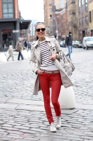 Beige Trenchcoat Outfits For Women: If you're seeking to take your casual look to a new level, marry a beige trenchcoat with red skinny jeans. For a more laid-back vibe, complete this getup with a pair of white canvas low top sneakers.