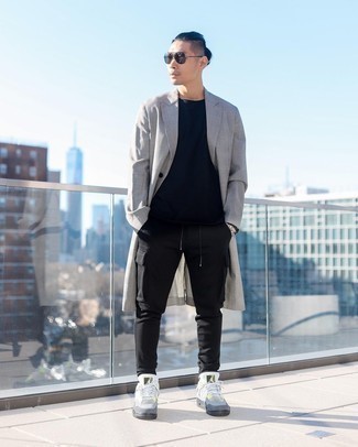 Grey Trenchcoat Outfits For Men: Make a fashionable entrance anywhere you go in a grey trenchcoat and black cargo pants. Grey canvas low top sneakers are an effortless way to punch up this look.