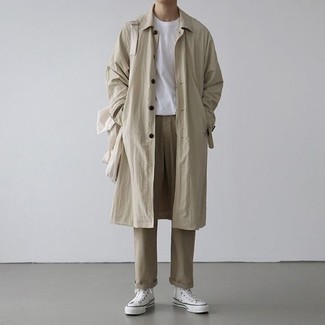 Beige Trenchcoat Outfits For Men: You'll be amazed at how very easy it is for any man to get dressed like this. Just a beige trenchcoat teamed with khaki chinos. Make this outfit more practical by finishing with white canvas high top sneakers.