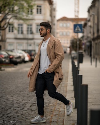 Navy Skinny Jeans Outfits For Men: This pairing of a tan trenchcoat and navy skinny jeans makes for the perfect base for an infinite number of looks. You could perhaps get a bit experimental on the shoe front and add a pair of grey athletic shoes to the mix.