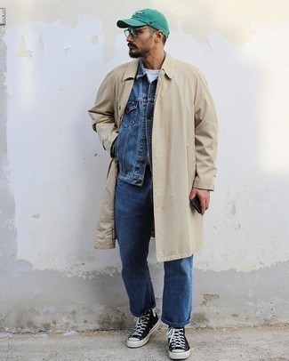 Tan Trenchcoat Outfits For Men: If you don't take your personal style lightly, go for a smart look in a tan trenchcoat and blue jeans. A trendy pair of black and white canvas high top sneakers is an easy way to infuse an air of stylish effortlessness into this ensemble.