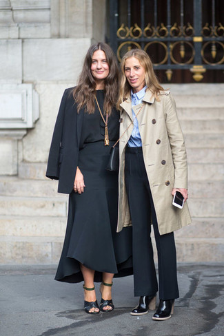 This combo of a beige trenchcoat and black dress pants might pack a punch, but it's also super easy to throw together. Black leather ankle boots tie the look together.