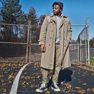 Tan Trenchcoat Outfits For Men: Pairing a tan trenchcoat with khaki chinos is a good pick for an effortlessly neat look. To introduce a more casual aesthetic to your ensemble, add a pair of black and white canvas high top sneakers to the equation.