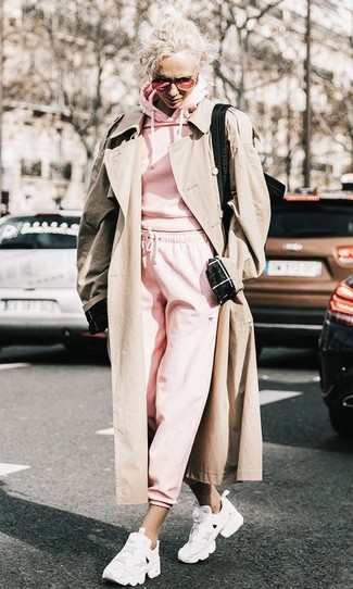 Beige Trenchcoat Outfits For Women: Consider pairing a beige trenchcoat with hot pink sweatpants to create an everyday look that's full of style and character. Add white athletic shoes to the mix to immediately bump up the wow factor of this look.