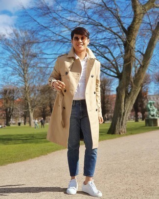 Beige Trenchcoat Outfits For Men: A beige trenchcoat and blue jeans are among those versatile pieces that have become the absolute wardrobe heroes in our menswear arsenals. White print canvas low top sneakers are a simple way to give a touch of stylish effortlessness to your outfit.