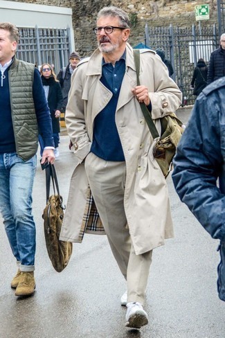 Tan Trenchcoat Outfits For Men: This combo of a tan trenchcoat and beige chinos will add alpha male essence to your ensemble. And if you want to immediately tone down this look with footwear, why not introduce a pair of white athletic shoes to the mix?