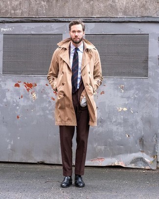 Beige Trenchcoat Outfits For Men: This is definitive proof that a beige trenchcoat and a dark brown suit are awesome when married together in an elegant getup for a modern guy. Rounding off with black leather loafers is a guaranteed way to infuse a carefree vibe into your ensemble.
