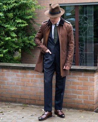 Dark Brown Trenchcoat Outfits For Men: You'll be amazed at how easy it is to get dressed like this. Just a dark brown trenchcoat married with a navy suit. For something more on the relaxed side to finish your outfit, introduce a pair of dark brown leather double monks to your outfit.