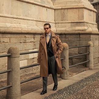 Dark Brown Trenchcoat Outfits For Men: A dark brown trenchcoat looks especially refined when married with a charcoal suit. Complete your ensemble with a pair of black leather loafers to infuse a hint of stylish effortlessness into your outfit.
