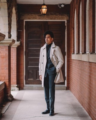 Men's Outfits 2021: You're looking at the hard proof that a beige trenchcoat and a navy vertical striped suit look awesome when teamed together in a classy outfit for today's guy. Black leather loafers complete this ensemble quite nicely.