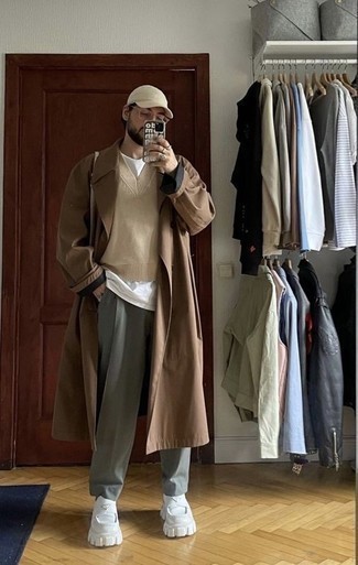 Baseball Cap Outfits For Men: This off-duty combination of a brown trenchcoat and a baseball cap is capable of taking on different nuances depending on the way you style it out. Put a different spin on this outfit by rocking a pair of white leather loafers.