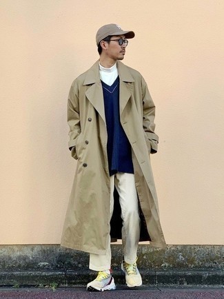 Tan Trenchcoat Outfits For Men: As you can see, it doesn't require that much effort for a man to look casually neat. Dress in a tan trenchcoat and beige corduroy chinos and be sure you'll look incredibly stylish. Feeling creative today? Dial down your getup by slipping into a pair of multi colored athletic shoes.