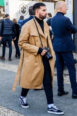 Tan Trenchcoat Outfits For Men: As you can see here, looking dapper doesn't take that much time. Just pair a tan trenchcoat with navy chinos and you'll look amazing. For times when this getup looks all-too-perfect, dial it down by finishing with a pair of navy and white canvas low top sneakers.