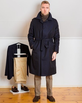 Navy Trenchcoat Outfits For Men: To look like a modern dandy with a great deal of class, rock a navy trenchcoat with khaki dress pants. Got bored with this ensemble? Enter dark brown suede desert boots to jazz things up.