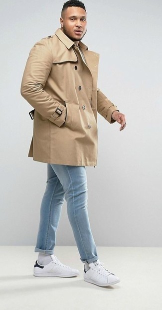 Tan Trenchcoat Outfits For Men: For a never-failing smart option, you can never go wrong with this pairing of a tan trenchcoat and light blue jeans. On the shoe front, go for something on the casual end of the spectrum and complete this getup with a pair of white and black leather low top sneakers.