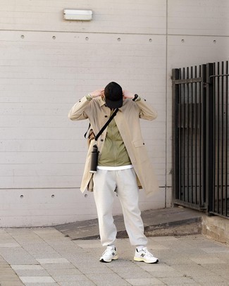 Trenchcoat Outfits For Men: This pairing of a trenchcoat and grey sweatpants is the perfect base for a casually stylish outfit. A pair of white and black athletic shoes immediately kicks up the wow factor of this outfit.