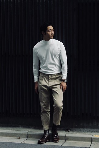 Tobacco Leather Casual Boots Smart Casual Outfits For Men: If you gravitate towards laid-back combos, why not try pairing a white turtleneck with beige chinos? Let your sartorial expertise truly shine by completing this look with a pair of tobacco leather casual boots.