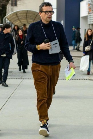 1200+ Outfits For Men After 40: The combination of a navy knit wool turtleneck and brown corduroy chinos makes for a killer casual getup. On the shoe front, this outfit is completed really well with navy canvas low top sneakers. A good, less conservative ensemble for guys in their forties.
