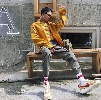 Yellow Horizontal Striped Turtleneck Outfits For Men: A put together combination of a yellow horizontal striped turtleneck and grey cargo pants will set you apart instantly. Rounding off with beige suede athletic shoes is a fail-safe way to introduce a more laid-back spin to your outfit.