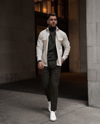 White Corduroy Long Sleeve Shirt Outfits For Men: When the setting permits a casual look, you can rock a white corduroy long sleeve shirt and charcoal vertical striped chinos. Let your styling savvy truly shine by rounding off this outfit with white canvas low top sneakers.